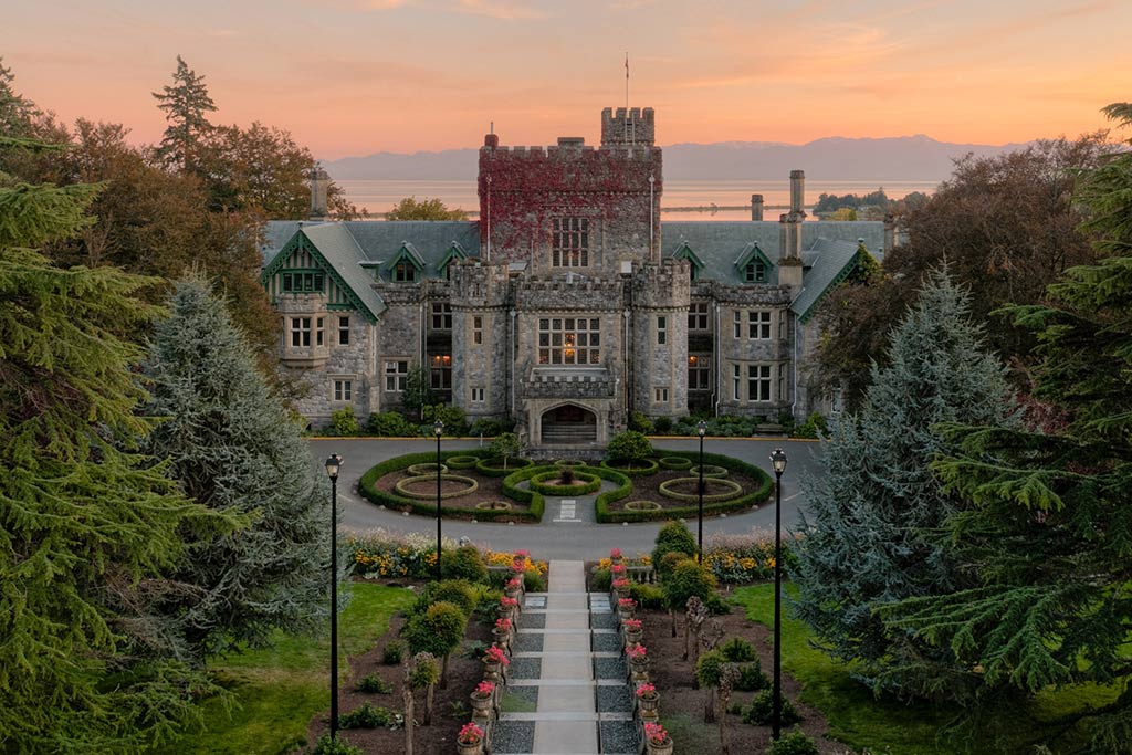 An aerial view of Hatley Castle with the Olympic mountains in the background