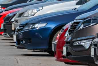 A row of cars parked in a lot