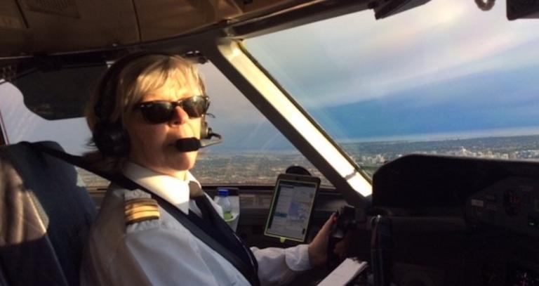 Alum Noreen Newton flying a commercial aircraft.