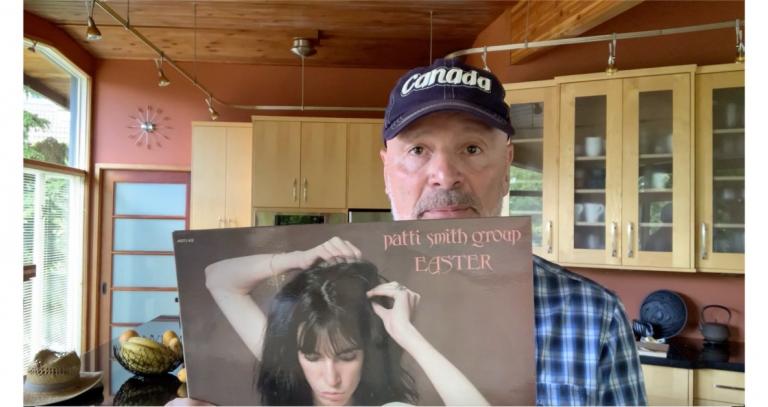 Still from video of President Philip Steenkamp, holding vinyl of Patti Smith Group's "Easter" album
