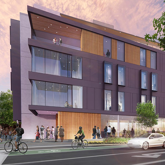A rendering of the new campus building on a busy street corner with a sunrise lighting up the wood, glass.