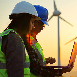 An RRU student stands with their peers in front of a glass wall, placing sticky notes together.