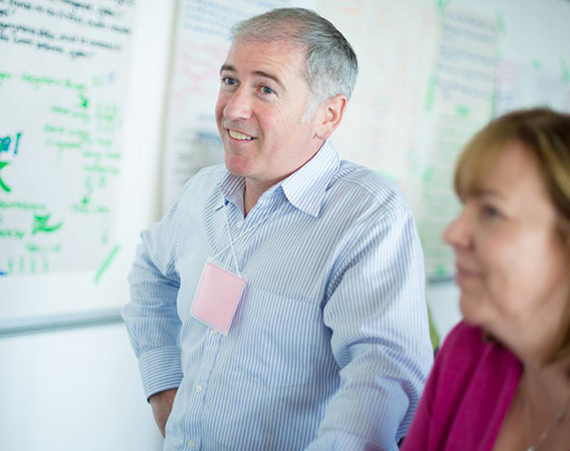Two students stand in front of a whiteboard. This image links to the Graduate Certificate in Systems Leadership in Higher Education program.