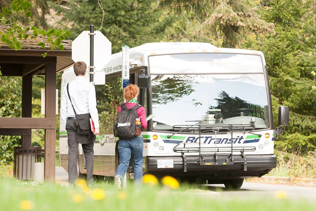 Two students board a BC transit bus on the Colwood Campus. This image links to the Colwood Campus parking page