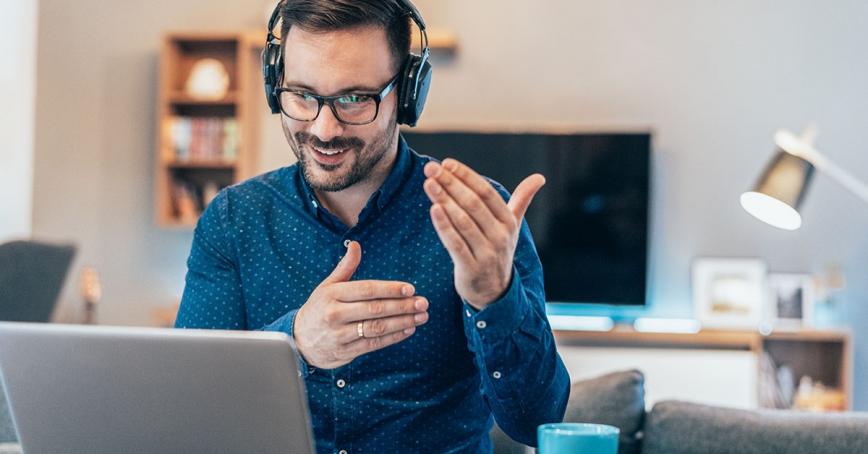 Person-speaking into their laptop and using hand gestures