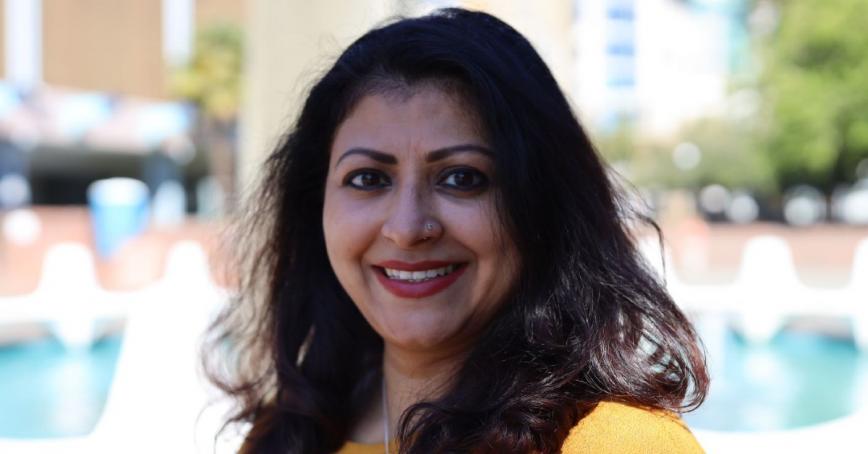RRU graduate Mazumdar smiling for a photo outdoors