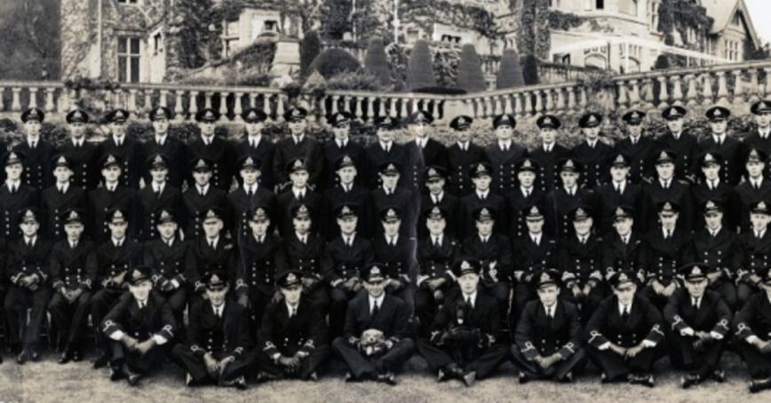 Class photo of military college graduates at RRU in black and white