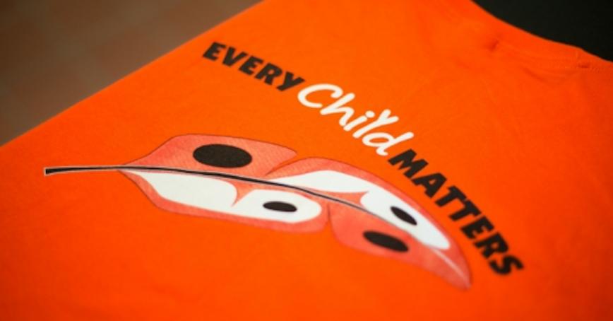 An orange t-shirt with "Every Chid Matters" and a feather.
