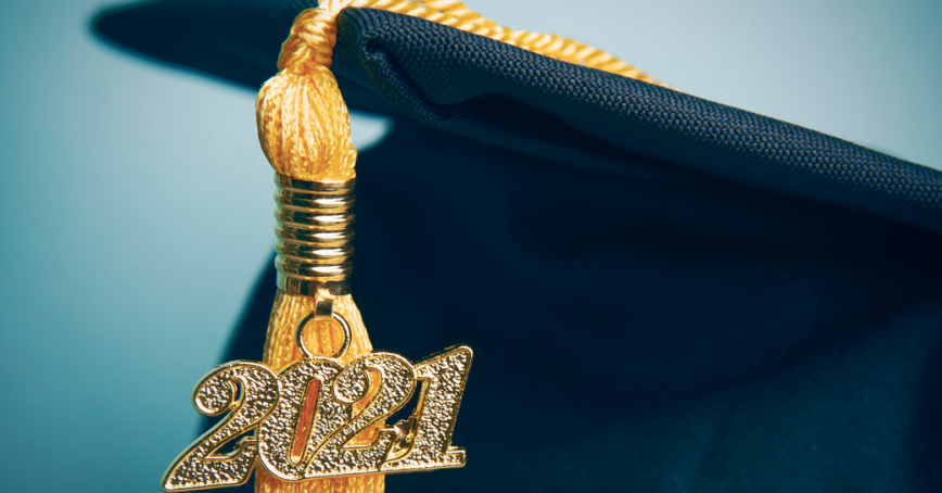 A grad cap with a gold tassel and 2021.