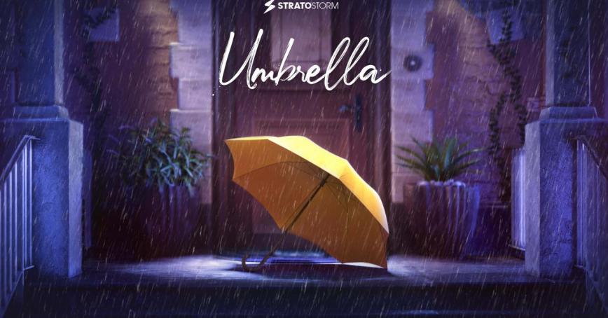 A yellow umbrella sits on a front porch with a spotlight on it. 