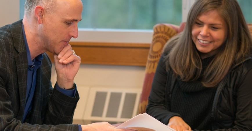 Two RRU leaders reviewing a document sitting around a table