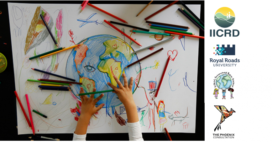Photo of child drawing globe with different coloured pencil crayons all over the table.