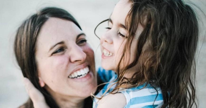 Mother and daughter smiling in each other arms