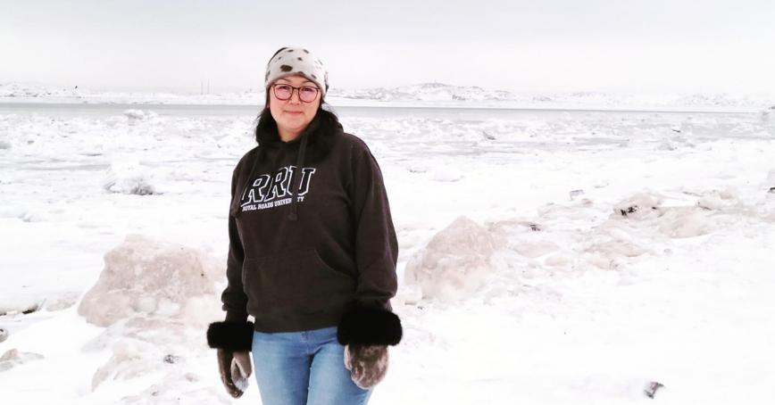 Inuk grad Elaine Uppahuak-Prusk at home in Nunvut, wearing sealskin mittens.