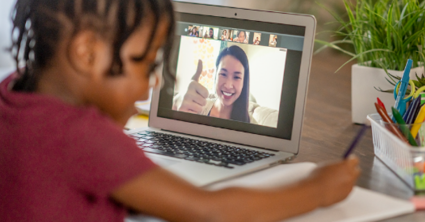 Child learning from a teacher on laptop