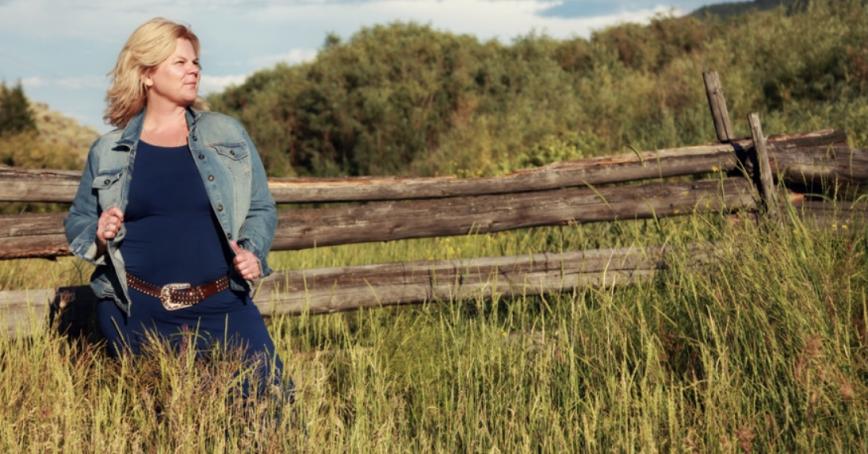 Robyn Grebliunas FNTC, standing next to a fence in a field