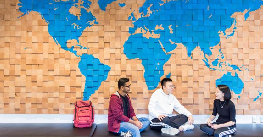 people in front of world map