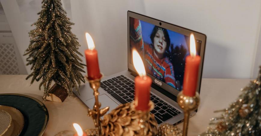 An image of candles and a video call on a laptop 