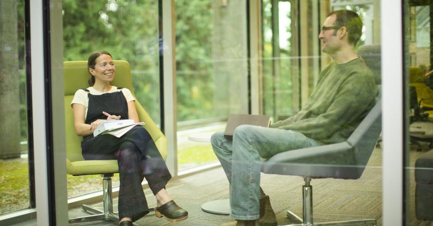 Two students at library working together 
