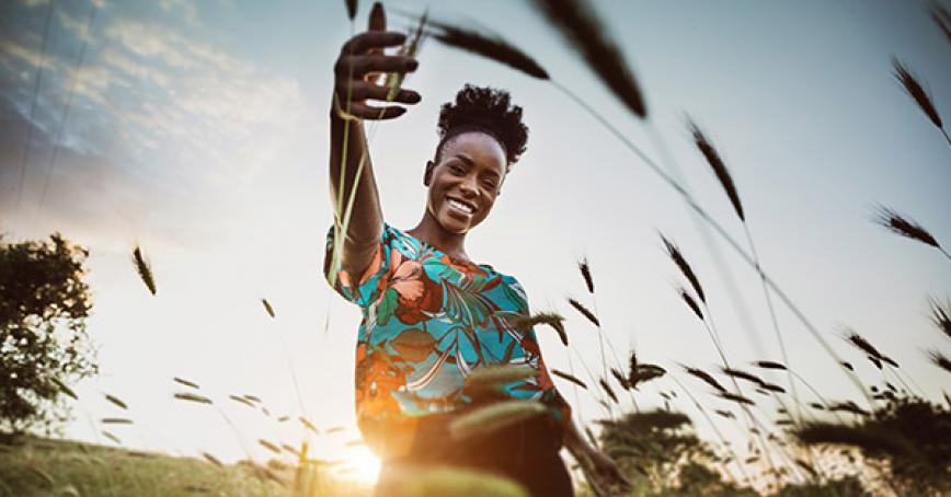 Student playing outside in a flower field