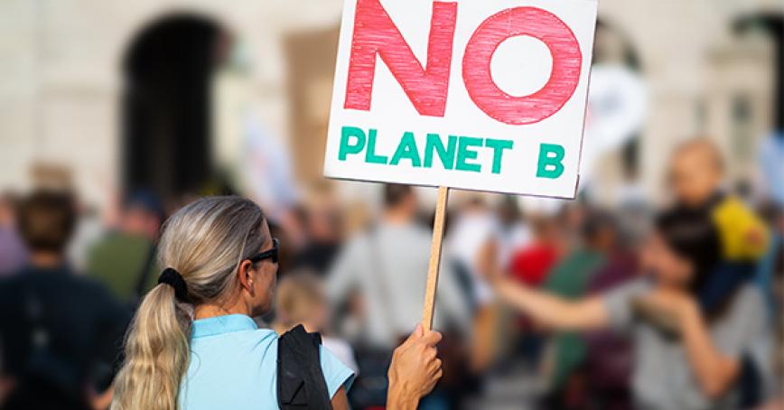 Student showing a no planet b sign