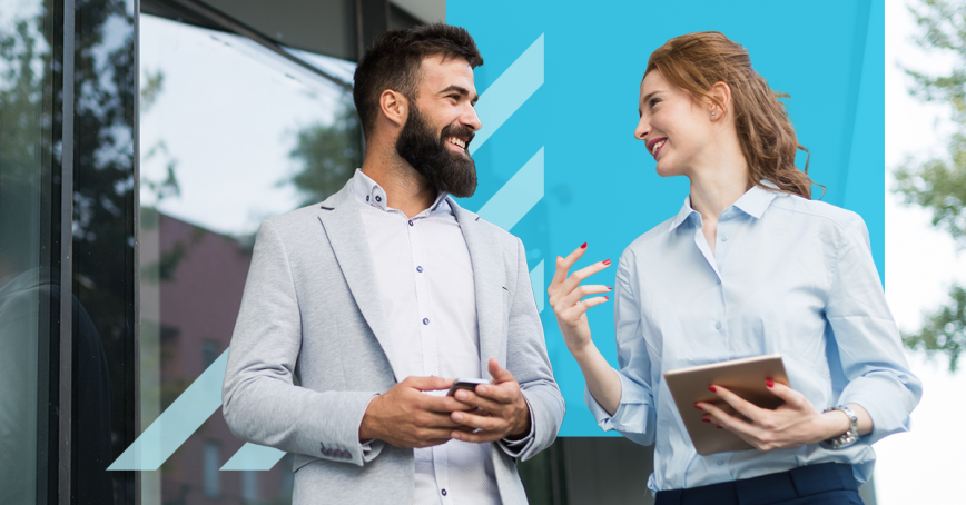 A male and female student talking. 
