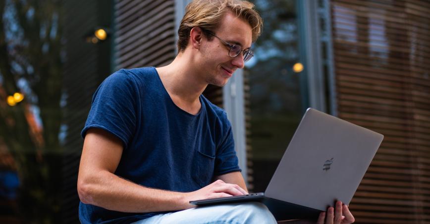 Someone looking at a laptop