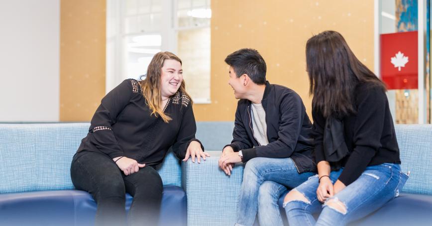 Students chatting in the HUB inside the Sherman Jen Building.