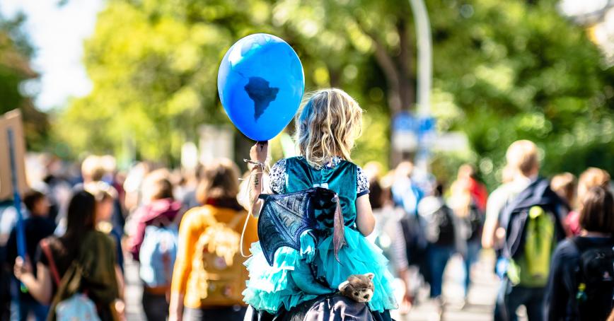 a child holding a earth globe