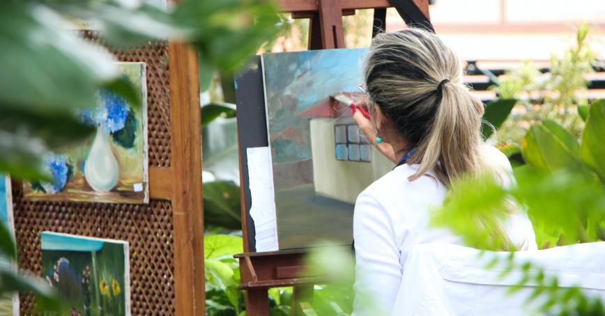 Someone painting outdoors