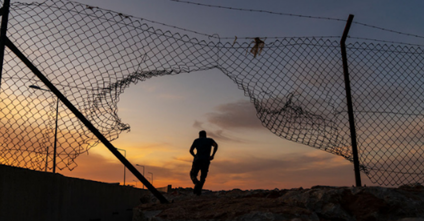 person running through fence