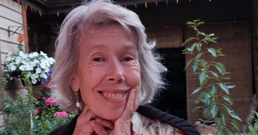 Head shot of Catherine Lang with a garden in the background