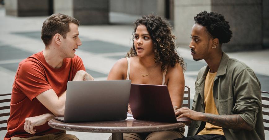 Three individuals sitting and talking