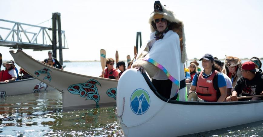 People in canoes arrive at Esquimalt Lagoon