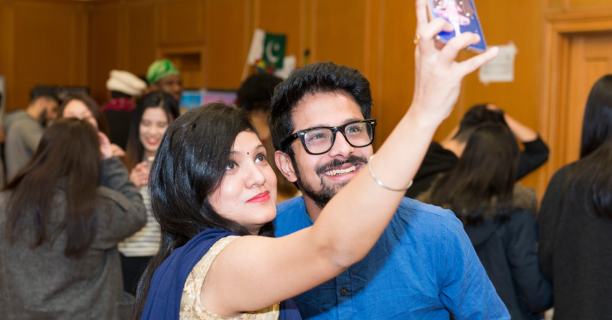 Two students pose for a selfie at an event at the RRU Grant Quarterdeck
