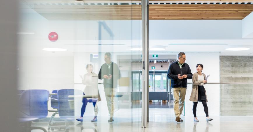 Student and professor walking in hallway