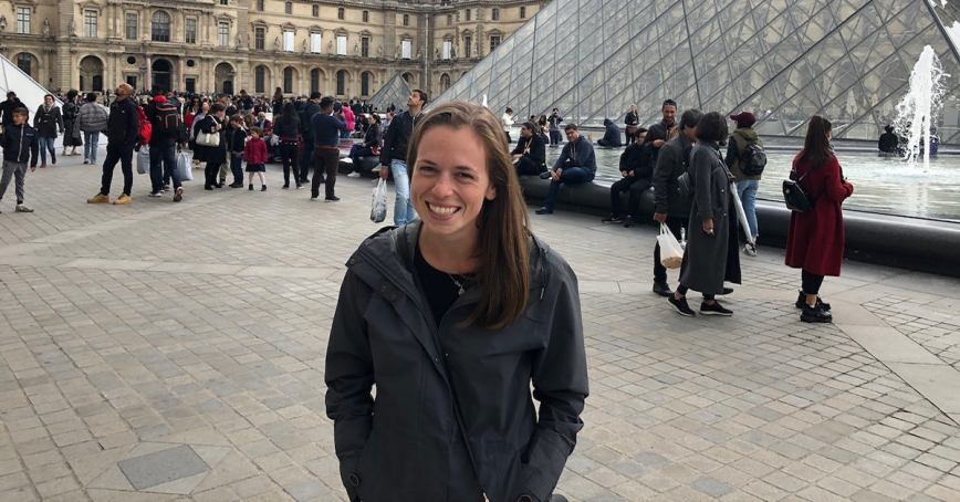 Taylar Bouwmeester stands in an outdoor square.