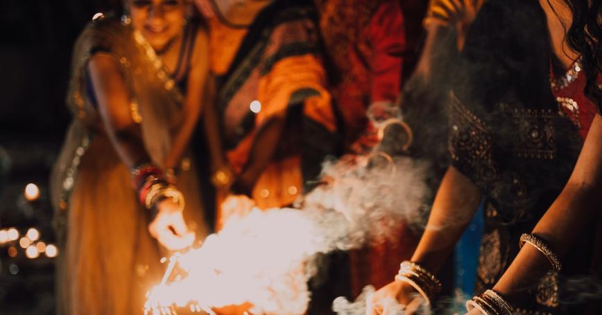People in the background lighting sparklers for Diwali