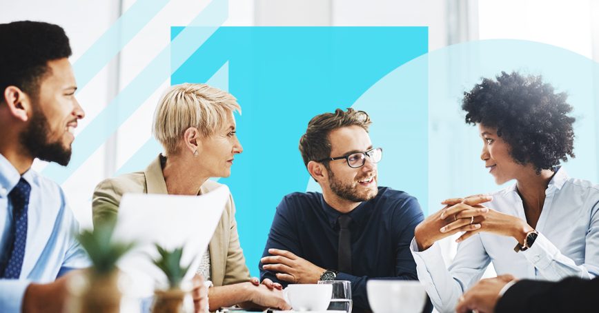 four people sitting around a table talking