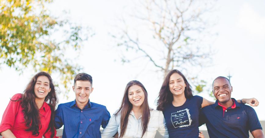 students sitting on a bench, smiling