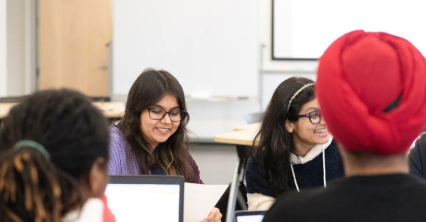 Four students sitting around a table.