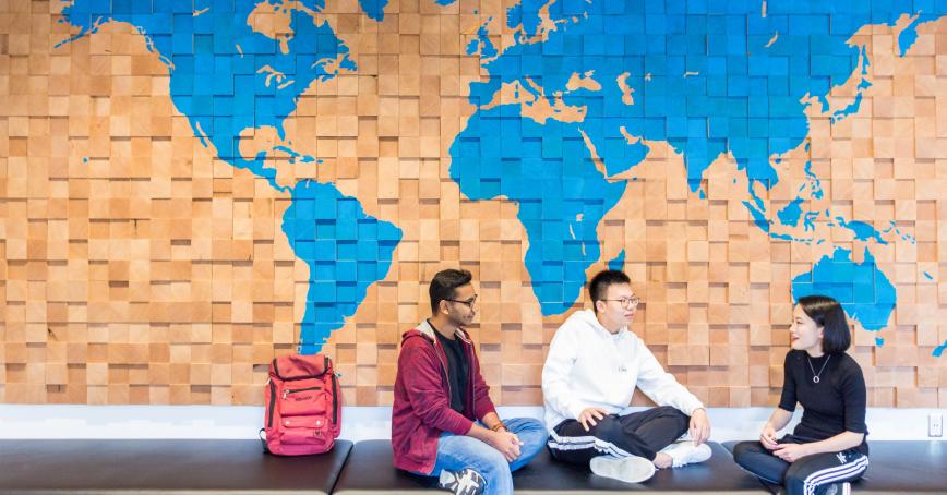 students talking infront of a map