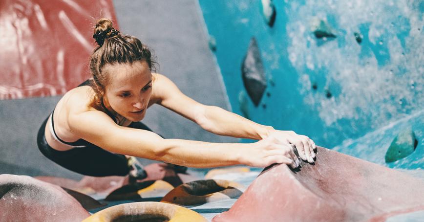 Women climbing an indoor rock climbing wall