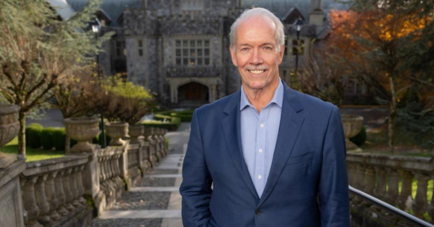John Horgan standing outside Hatley Castle at Royal Roads University.