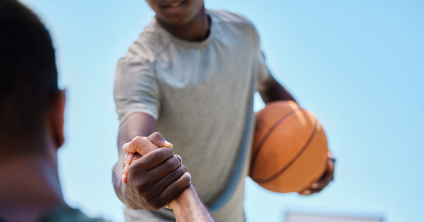 Two people playing basketball.
