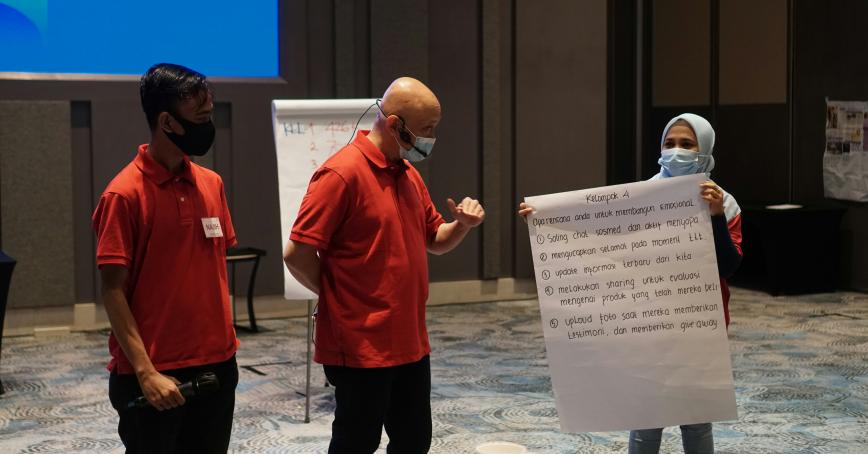 workers presenting with flipcharts