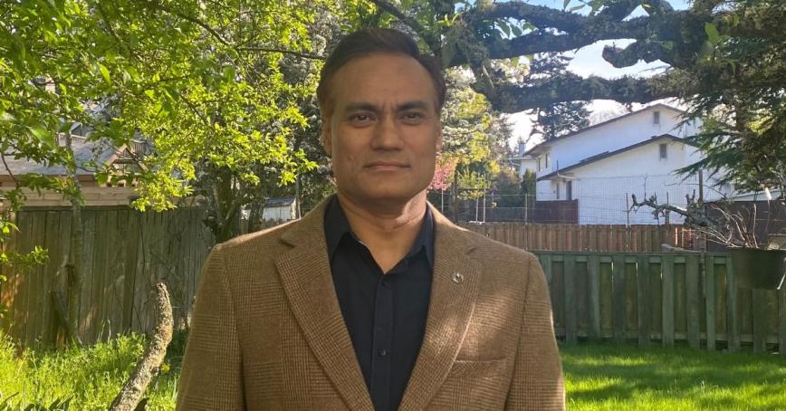 Rudra Shrestha standing in front of a natural environment