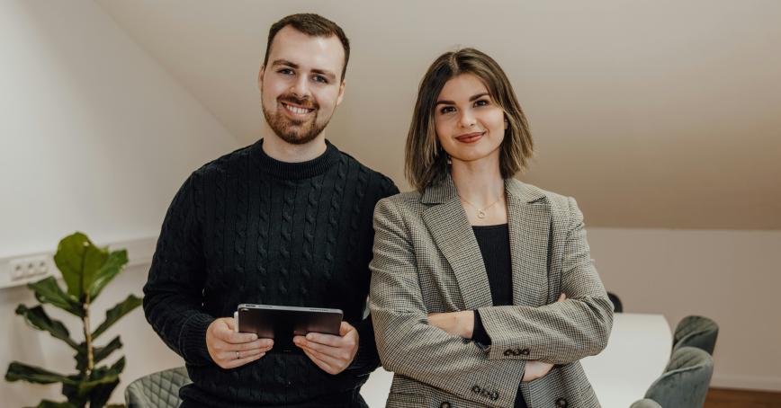 two entrepreneurs smiling and looking at the camera