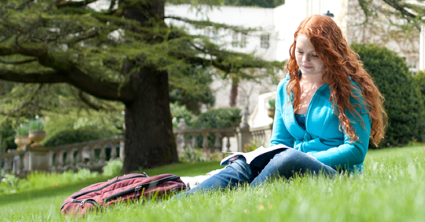 student studying on the lawn at RRU