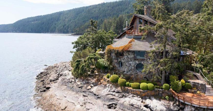 An aerial view of the Bloom Castle by the sea along the coastline of Salt Spring Island.